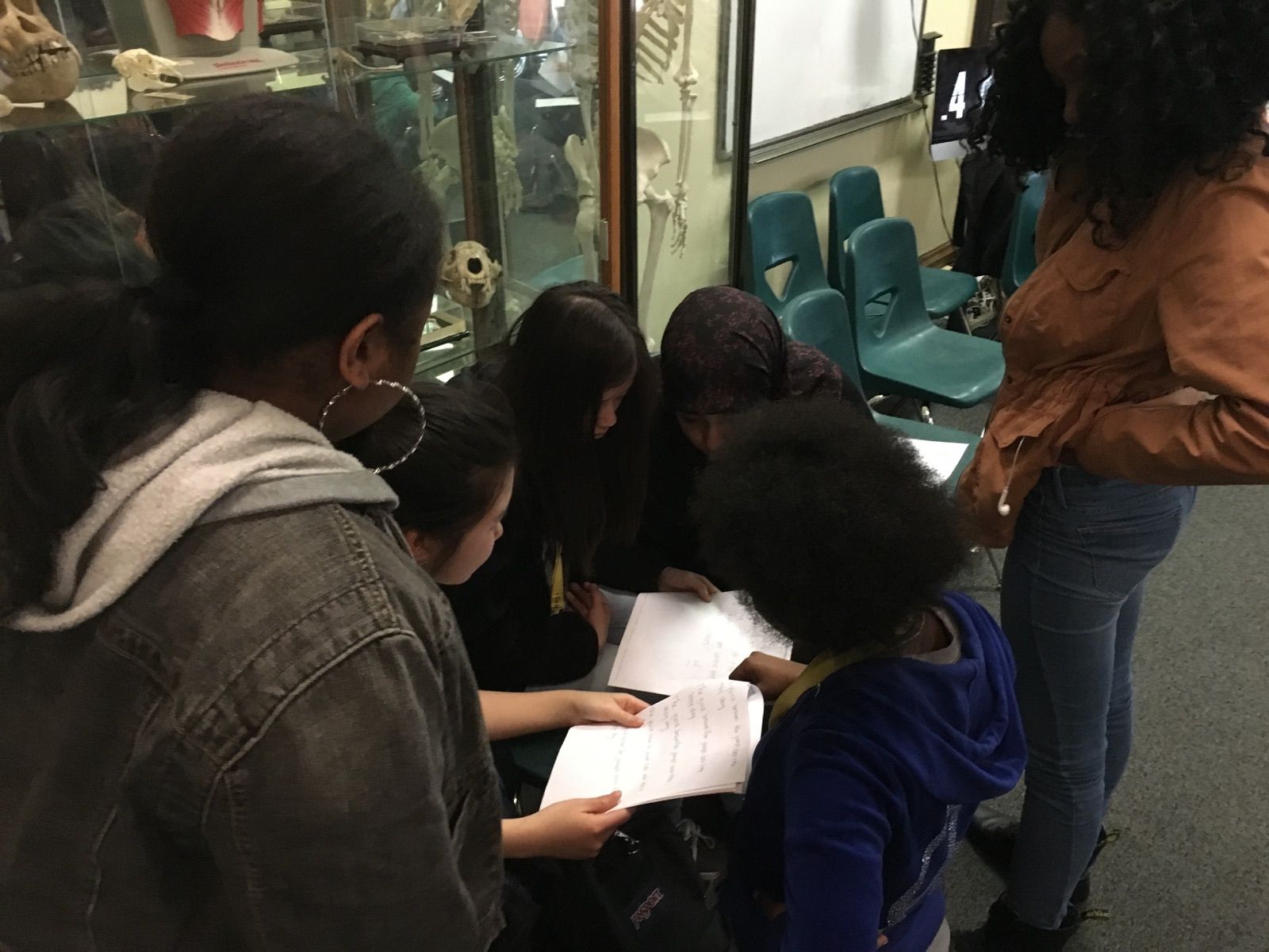 Students in the Karabots Junior Fellows Program examine a questioned document during a lesson on handwriting analysis