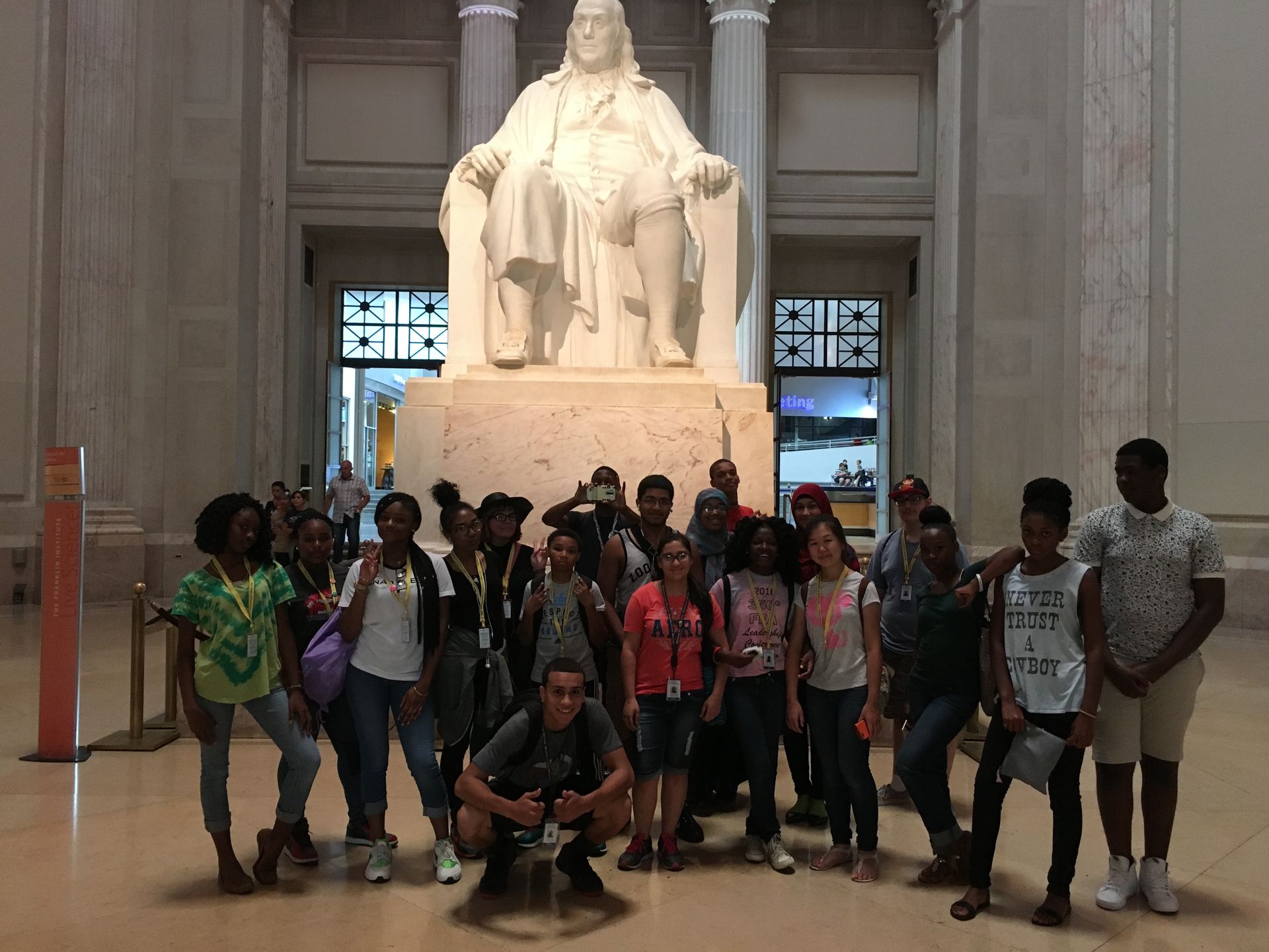 The Karabots Junior Fellows pose in front of the statue of Benjamin Franklin at the Franklin Institute