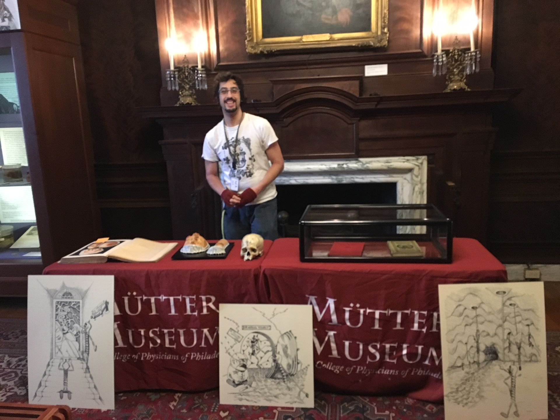 Youth Program Coordinator Kevin Impellizeri stands behind a table of specimens and books related to syphilis for a lesson at the Mütter Museum