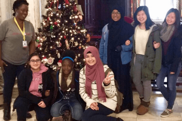 Students in the Karabots Junior Fellows Program pose in front of the Mütter Museum Christmas tree