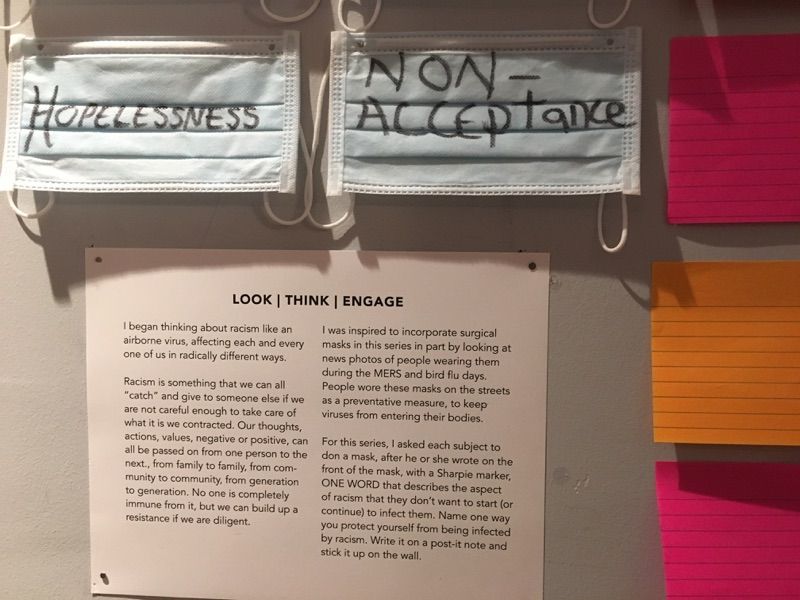 Surgical masks and an exhibit label from Racism is a Sickness