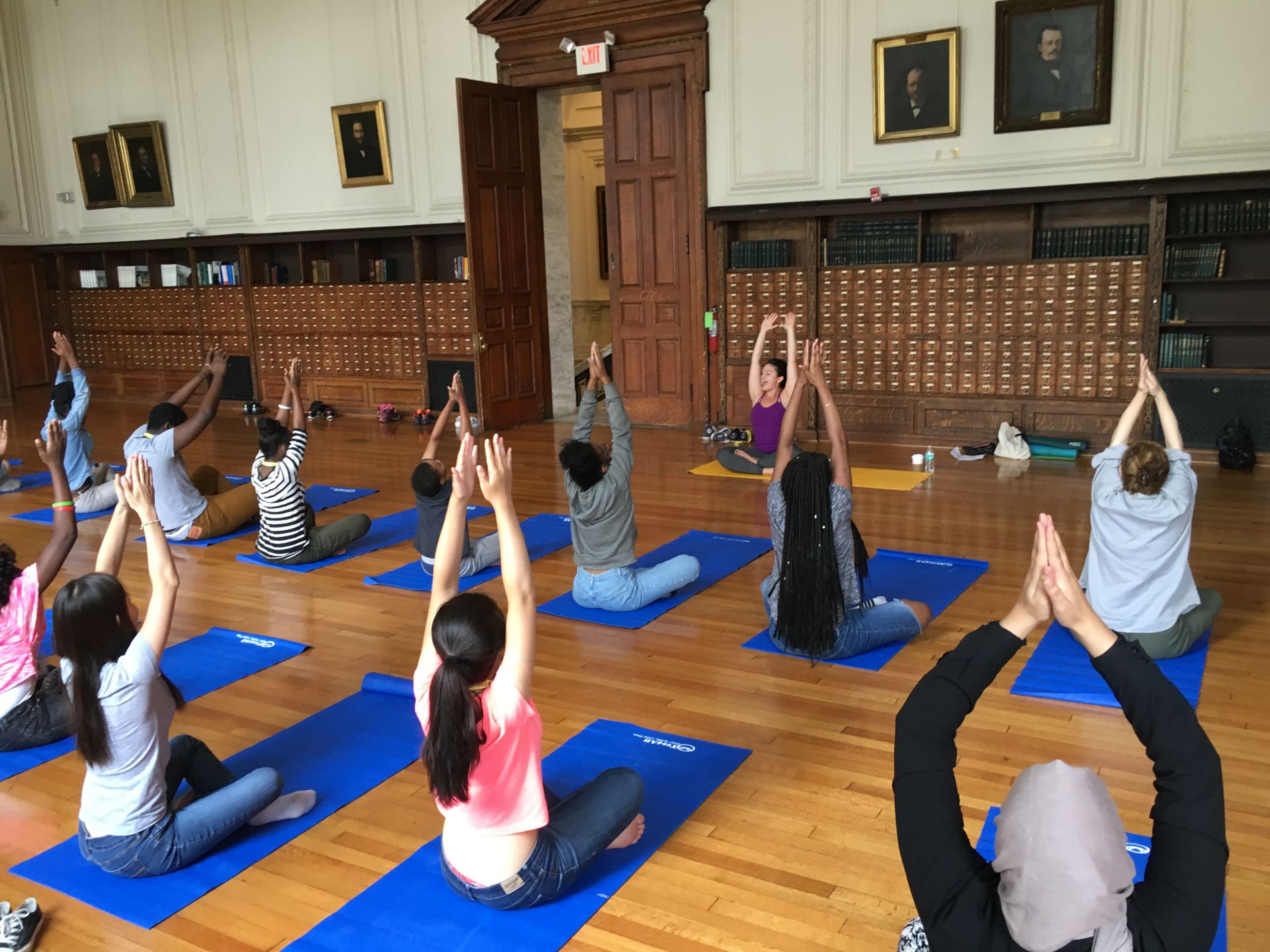 The Karabots Junior Fellows take part in a yoga demonstration led by Laura Baehr