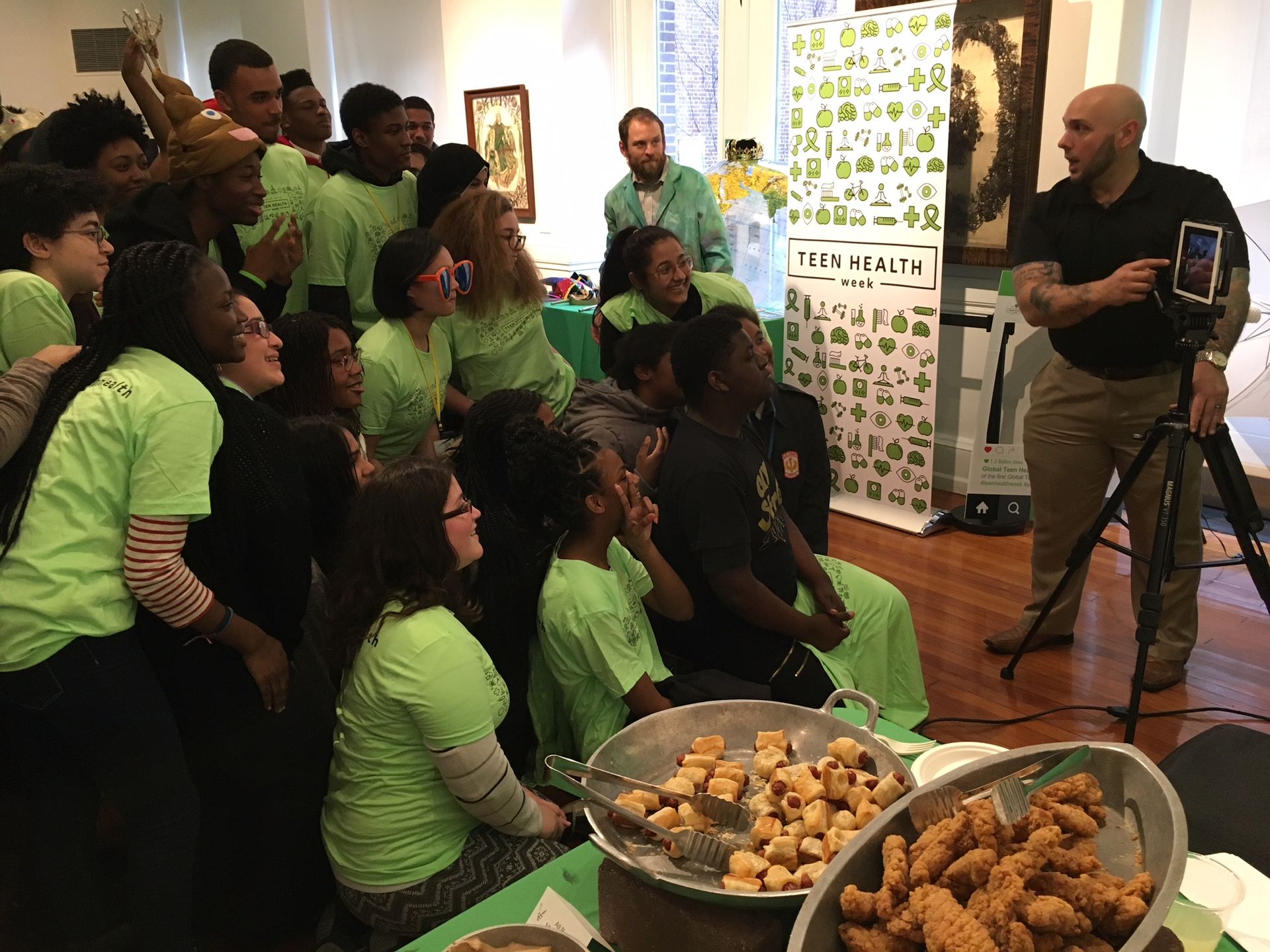 Teens dressed in lime green t-shirts pose together for a photograph during a March 23, 2018, Teen Health Week panel on substance use and abuse