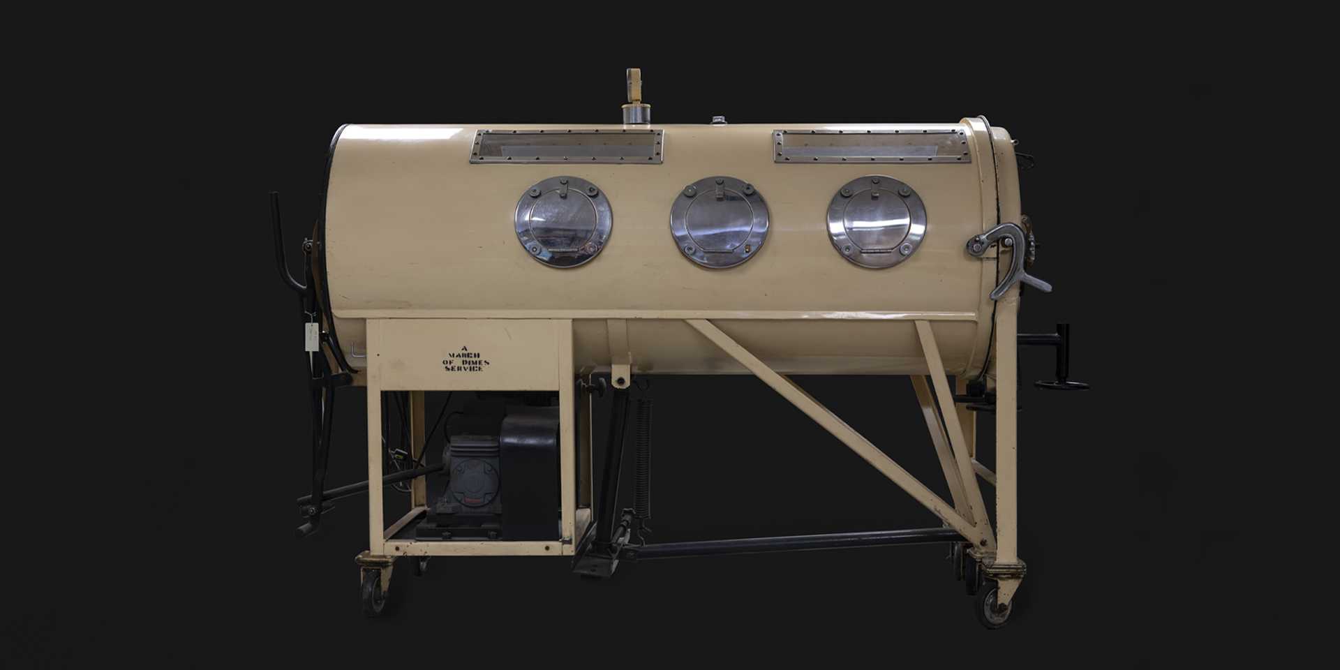 Yellow iron lung against black background