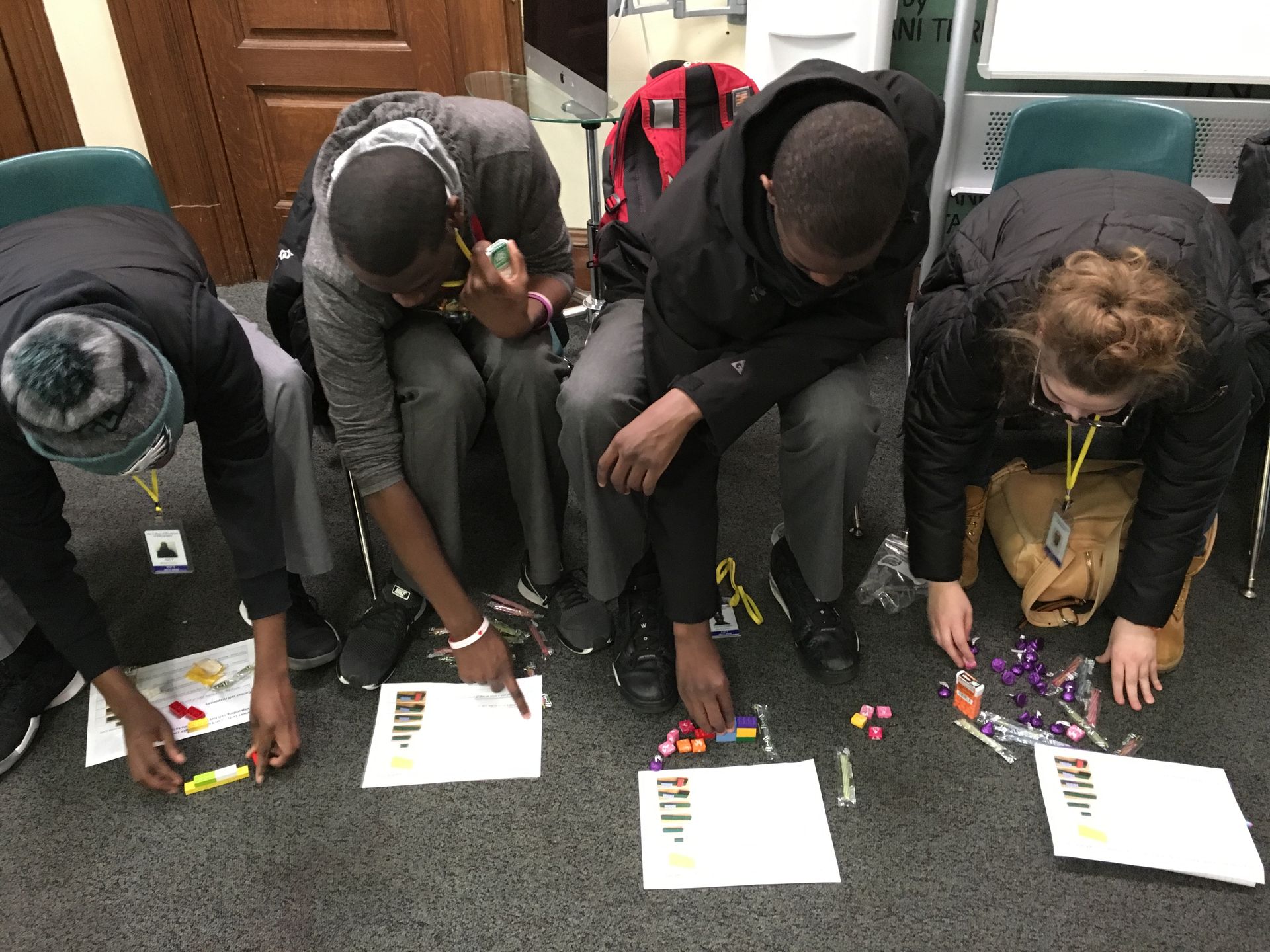 Students in the Karabots Junior Fellows Program take part in an activity about cancer biology by assembling walls made of Legos
