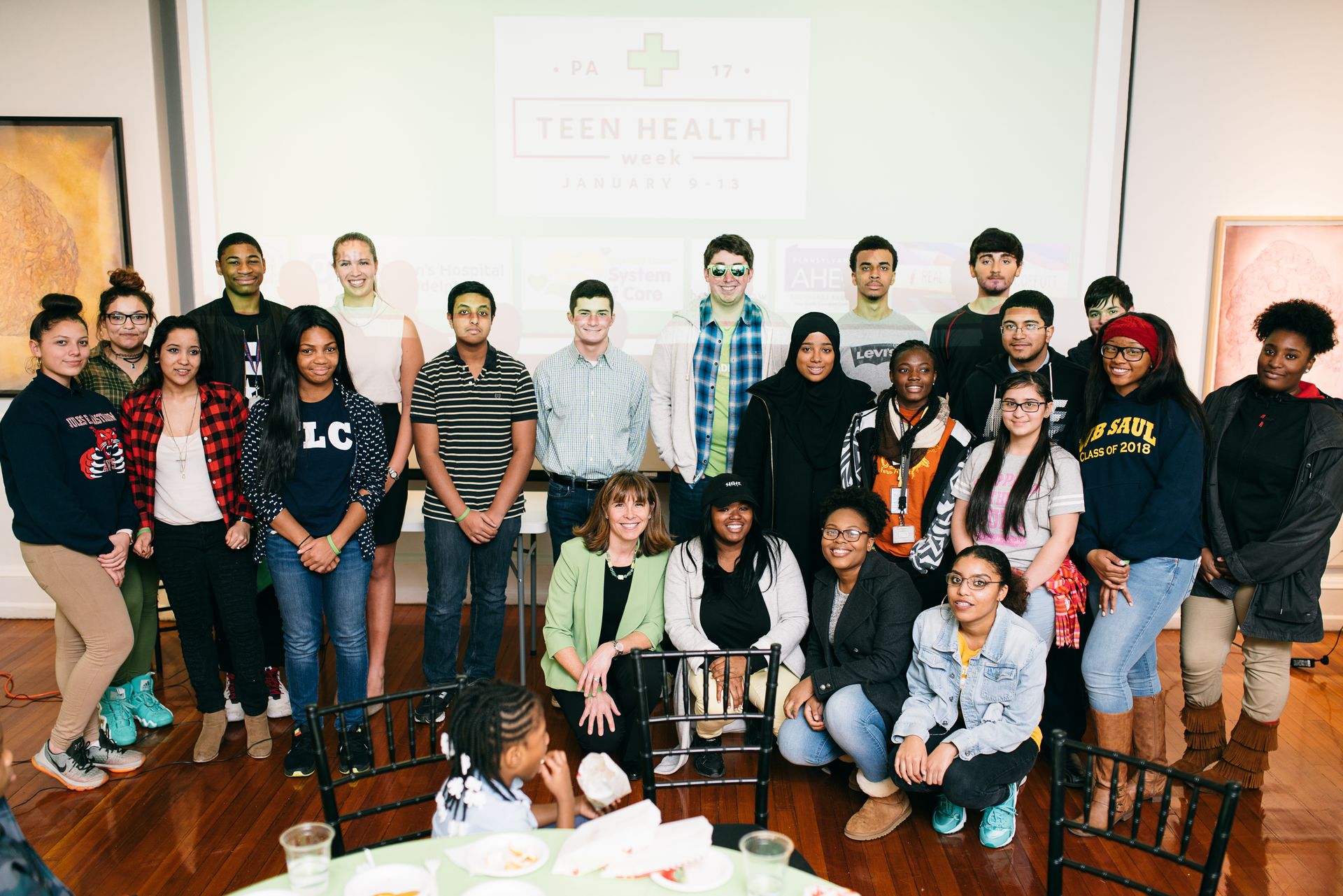 Philadelphia teens pose for a group photo with Dr. Laura Offutt at the Teen Health Week Party Photo: Hieu Pham