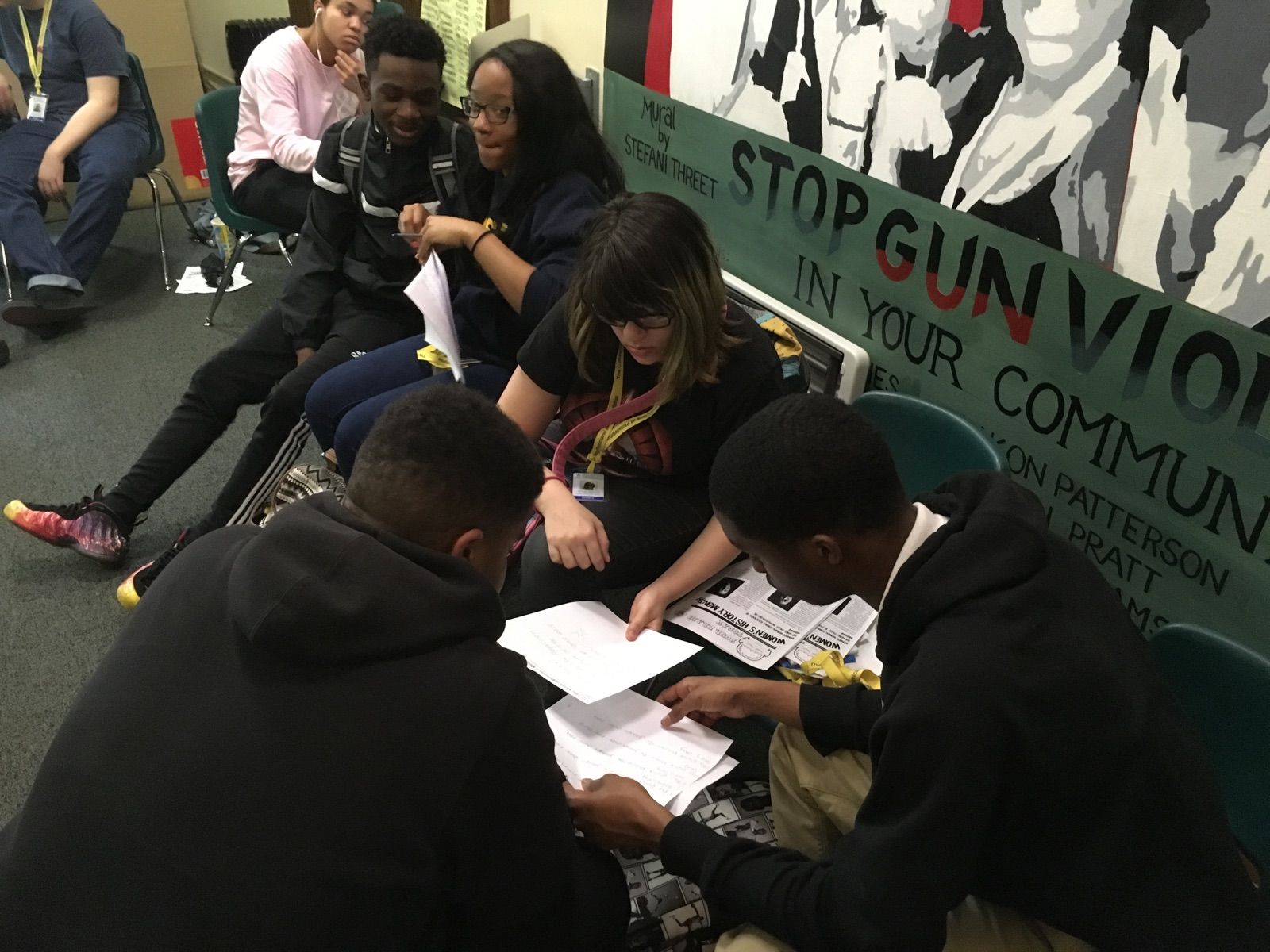 Students in the Karabots Junior Fellows Program examine a questioned document during a lesson on handwriting analysis